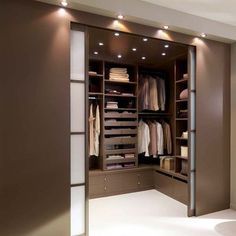 an empty walk in closet with lights on the ceiling