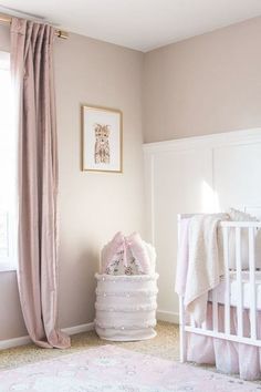 a baby's room with pink and white decor