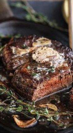 the steak is being grilled on the grill with a fork and some potatoes next to it