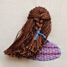 a close up of a piece of cloth with a tassel on top of it