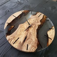 a clock made out of wood on top of a table