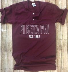 50/50 cotton poly blendUnisex fitTwo button baseball style shirtShown on a Maroon shirt with white text Pi Beta Phi, Maroon Shirts, Memphis Tn, Henley Shirt, Style Shirt, Henley Shirts, 50 50, Shirt Style, Men's Polo Shirt