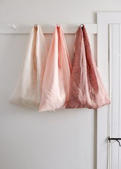 three towels hanging on the wall in front of a door with text over it that reads fold - up market tote