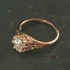 Rose Gold Engagement Ring Oval Solitaire Filigree Ring Aurora Ring Antique Style Ring Vintage Style Ring Hand Cast in our Studio To awaken from true loves first kiss, that is what we remember from Sleeping Beauty. Aurora was the princess' name. This beautiful ring emanates with Victorian style elegance and class. The delicate filigree encases the oval stone of your choice which is held by 6 prongs. The genuine white topaz, white sapphire, cubic zirconia, or moissanite measures 5mm by 7mm. The ri Rose Gold Diamond Promise Ring With Intricate Design, Rose Gold Intricate Design Diamond Promise Ring, Rose Gold Intricate Design Promise Ring, Rose Gold Rings With Intricate Design, Oval Engraved Ring With Intricate Design For Anniversary, Rose Gold Filigree Promise Ring, Exquisite Oval Filigree Ring, Oval Engraved Ring With Brilliant Cut For Promise, Heirloom Oval Filigree Ring With Prong Setting