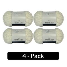 four balls of yarn in white with black text on the front and back of each ball