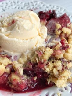 a white plate topped with fruit cobbler and ice cream