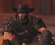 a man in a cowboy hat and leather outfit sitting on a motorcycle with his hands behind his back