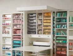 an organized craft room with lots of storage