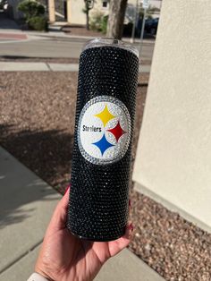 a hand holding a black tumbler cup with a pittsburgh football logo on the side