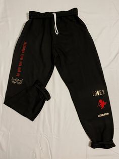 BE YOUR OWN MAIN CHARACTER SWEATPANTS + a surprise matching vinyl sticker. These trendy and unique graphic sweatpants are made on black material with red and gold graphic details. Perfect as a valentines day gift or just treat yourself gift :) I want to create a brand that is a constant reminder to be TRU to who you are as a person; that brings your own unique style into it as well. Life is short, be WHOEVER you want to be! You are your own main character, always. Pair this sweatshirt with whate Black Graphic Print Loungewear Pants, Black Graphic Print Joggers For Streetwear, Black Joggers With Graphic Print For Streetwear, Casual Black Sweatpants With Graphic Print, Casual Black Graphic Print Joggers, Black Casual Joggers With Graphic Print, Black Hip Hop Sweatpants For Loungewear, Hip Hop Style Graphic Print Sweatpants For Loungewear, Hip Hop Sweatpants With Graphic Print For Loungewear