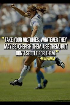 a woman kicking a soccer ball with a quote from mia hamm on her side