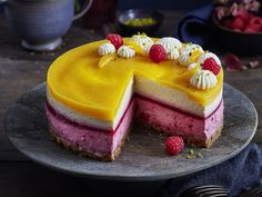 a cheesecake with raspberries and whipped cream