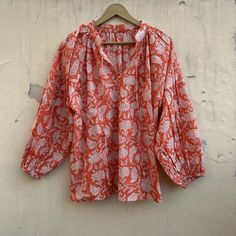 This divine cotton blouse is as light as can be. With the most romantic billowed sleeves, elastic cuffs, and two optional ties at the front. The flowing fabric features a sweet floral classic Indian Buti block print in cinnamon on soft white cotton. A timeless feminine piece. Material ~ 100% Cotton. Depending on each individual, some find the material sheer.  Garment Care ~ We recommend a gentle, cold water hand wash using natural detergents, and hang drying in the shade. Handcrafted garments ar Billowy Blouson Sleeve Bohemian Peasant Top, Bohemian Peasant Top With Billowy Blouson Sleeves, Billowy Bohemian Peasant Top With Blouson Sleeves, Bohemian Tops With Lantern Sleeves, Bohemian Tops With Floral Print And Bishop Sleeves, Bohemian Tops With Lantern Gathered Sleeves, Bohemian Tops With Lantern Elastic Sleeves, Bohemian Billowy Top With Blouson Sleeves, Bohemian Blouse With Puff And Gathered Sleeves