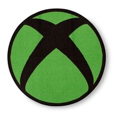 a green and black patch with an x logo on the center, in front of a white background