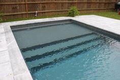 an empty swimming pool in the middle of a backyard