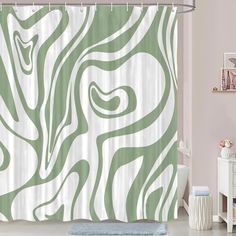 a bathroom with a green and white shower curtain in the shape of a zebra print