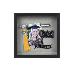 a graduation cap and tassel in a shadow box with the graduate's name on it