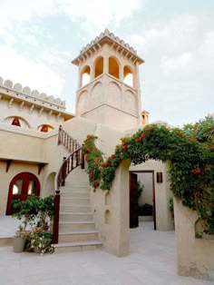 an outside view of a building with stairs and flowers