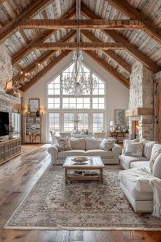 a living room filled with lots of furniture and a chandelier hanging from the ceiling