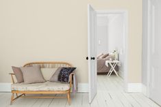 an open door leading to a bedroom with pink walls