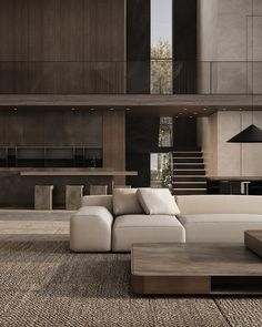 a large white couch sitting in a living room next to a wooden table and stairs