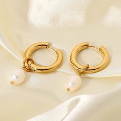 Stay on-trend with these fashionable 18k gold plated stainless steel chunky hoop earrings, accented with the classic beauty of freshwater pearls, making them a perfect blend of contemporary and timeless style. Detachable Freshwater Pearl Pendant so can be worn as just a hoop. 🌟Stainless steel  💛18K PVD gold plated 💦 Fully waterproof 🌟Hypoallergenic 🌟Tarnish free 💖Designed for 24/7 wear ✨Nickel and Lead free 🧡🌟 All jewellery comes inside a velvet drawstring pouch 🌟🧡 Gold Hoop With Pearl, Modern Gold Hoop Earrings With Pearl Charm, Trendy Gold Pearl Charm Earrings, Trendy Gold Hoop Earrings With Pearls, Trendy Round Pearl Earrings, Trendy Hoop Pearl Earrings, Trendy Pearl Hoop Jewelry, Modern Pearl Hoop Earrings As Gift, Medium Hoop Earrings