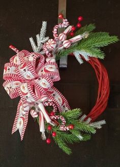 a christmas wreath with candy canes and bows