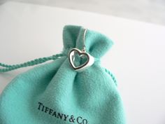 Overview:Time to pull your hair back and show off your awesome earrings! Offered for sale is a gorgeous and elegant pair of Tiffany and Co. Sterling Silver Modern Geometric Heart Dangling earrings. This pair looks fabulous, cosmopolitan, and yet retains a very dainty and feminine touch to it. Extremely elegant and comfortable piece! You will feel playful, modern and super stylish while wearing these earrings. Great pair to wear for work, a night in town, at a party, or just going to dinner with Elegant Heart Shaped Earrings For Gift, Luxury Heart-shaped Drop Earrings For Valentine's Day, Luxury Earrings With Heart Charm, Elegant Heart Pendant Earrings For Weddings, Luxury Heart Cut Earrings For Gift, White Gold Heart Charm Earrings For Wedding, Luxury Silver Heart Earrings For Wedding, Luxury Heart Cut Earrings As A Gift, Wedding White Gold Earrings With Heart Charm