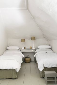 two beds in a room with white walls