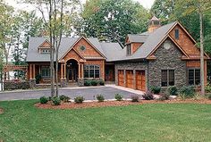 this is an image of a house in the country style with stone and wood accents