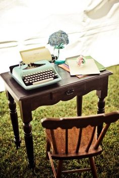 an old fashioned desk with a typewriter on it