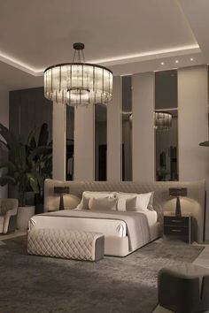 a bedroom with a large bed and chandelier