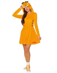 a woman in an orange dress is wearing a cat mask on her head and yellow shoes