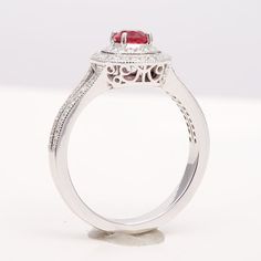 At 0.52 carats, this round brilliant spinel has an unmatched red color. Set on a wreath of diamonds the ring has an illusion of a both a bigger stone plus they look beautiful and sparkly. The diamonds that run onto the band of the ring lays all the importance on the centrally set spinel.  Order online info@jupitergem.com Ruby Ring With Pave Setting And Diamond, Ruby Ring With Diamond Pavé Setting, Formal Red Diamond Ring With Pave Setting, Classic Red Diamond Ring With Pave Setting, Classic Ruby Ring With Pave Setting, Classic Red Diamond Ring With Halo Setting, Red Oval Diamond Ring With Pave Setting, Red Pave Setting Rings, Red Rings With Pave Setting