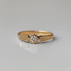 a gold ring with a diamond in the center