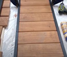 a pair of shoes sitting on top of a wooden floor next to some construction supplies