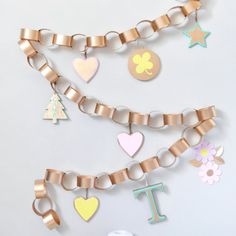 a white table topped with lots of different types of paper hearts and letters on it