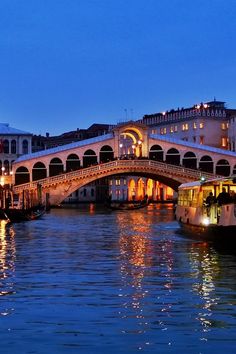 a bridge that is over some water at night