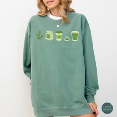 Embrace our matcha sweatshirt! This sweatshirt is perfect for anyone who loves matcha or appreciates aesthetic shirts! Treat yourself or surprise a friend with this thoughtful gift!  👕 COMFORT COLORS 1566 SWEATSHIRT  80% ring-spun cotton and 20% polyester. The fabric is 3-end garment-dyed, ring-spun, color-blast fleece with a 100% cotton face. Each sweatshirt comes with a relaxed fit, a rolled-forward shoulder, and a back neck patch. 👕 SIZING & CARE Shirt runs true to size. If you prefer an ov Green Crew Neck Top With Screen Print, Green Crew Neck Top For Loungewear, Green Crew Neck Sweatshirt With Graphic Print, Green Cotton Sweatshirt With Screen Print, Green Cotton Screen Print Sweatshirt, Green Cotton Sweater With Screen Print, Green Graphic Print Top For Loungewear, Green Crew Neck Sweatshirt With Screen Print, Green Crew Neck Sweater With Screen Print