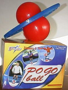 a red ball sitting on top of a box next to a blue plastic pencil holder