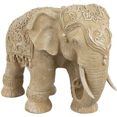 an elephant statue with intricate designs on it's body and tusks, standing in front of a white background