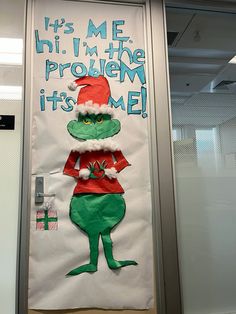 the grinch door decoration is decorated with santa's hat