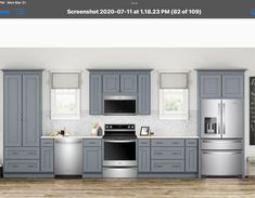 a kitchen with gray cabinets, white appliances and wooden floors is shown in this image