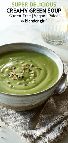 a bowl filled with creamy green soup on top of a table