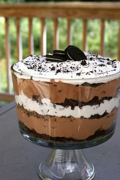 a cake that is sitting on top of a glass plate with an oreo cookie on it