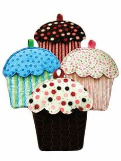 four different colored cupcakes with polka dots on them