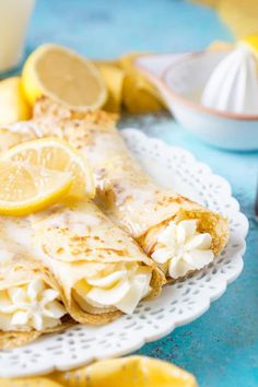 there is a plate with lemon crepes on it