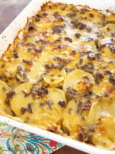 a casserole dish filled with potatoes and meat