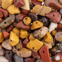 a pile of different colored rocks with holes in them