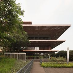 the building is made out of wood and has many plants growing on top of it